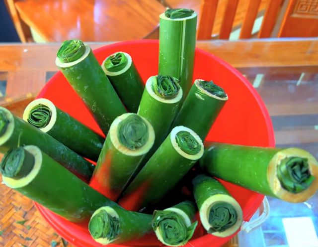 Cho gạo nếp vào ống lam sau đó cho một ít nước sôi vào ống lam và nhét lá chuối vào đầu ống lam - Ảnh sưu tầm Cho gạo nếp vào ống lam sau đó cho một ít nước sôi vào ống lam và nhét lá chuối vào đầu ống lam - Ảnh sưu tầm